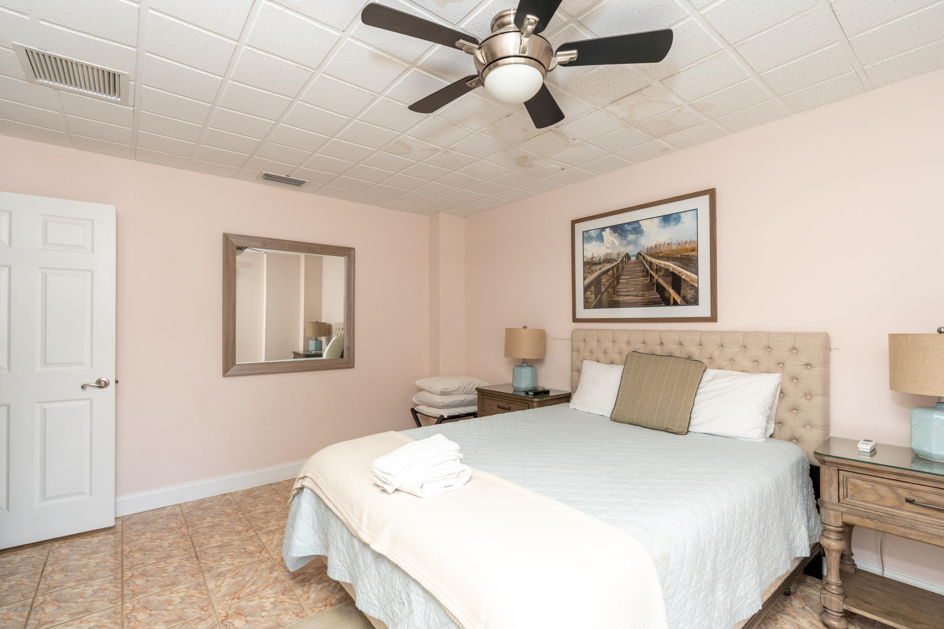4 3rd Street St. Augustine, FL 32080 - Photo 14 of 47 a bedroom with a large bed and a chandelier