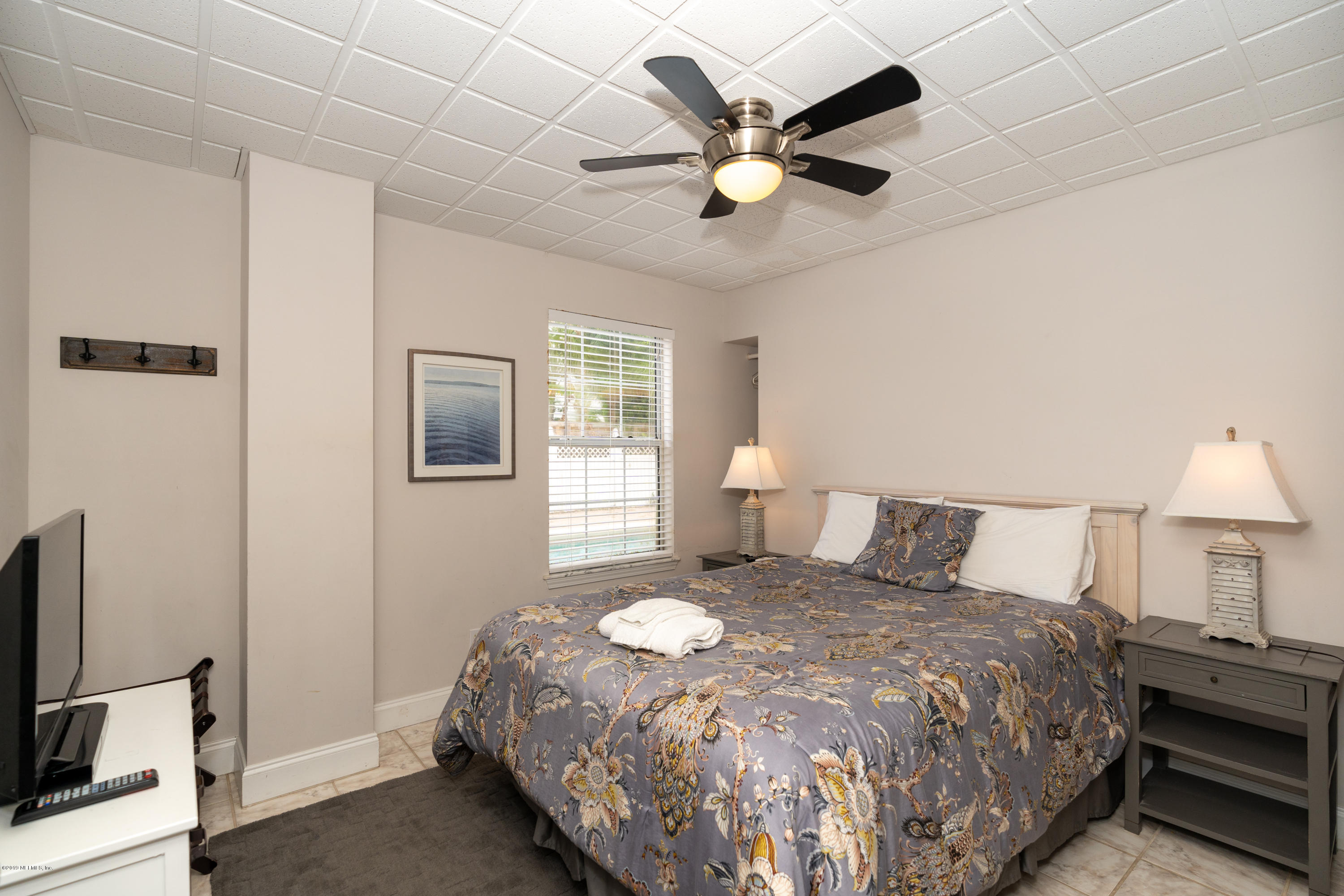 4 3rd Street St. Augustine, FL 32080 - Photo 16 of 47 a bedroom with a bed and a chandelier