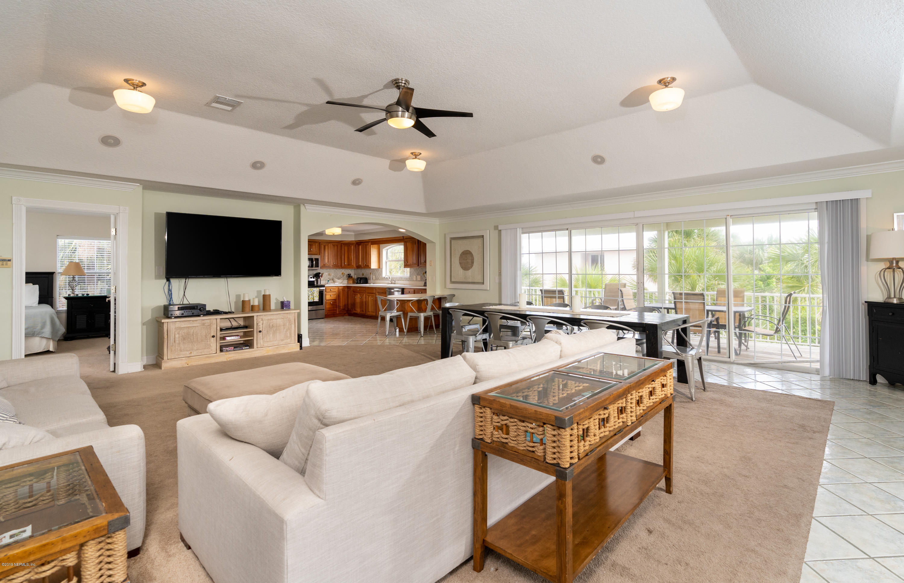 4 3rd Street St. Augustine, FL 32080 - Photo 18 of 47 a living room with furniture a flat screen tv and a large window
