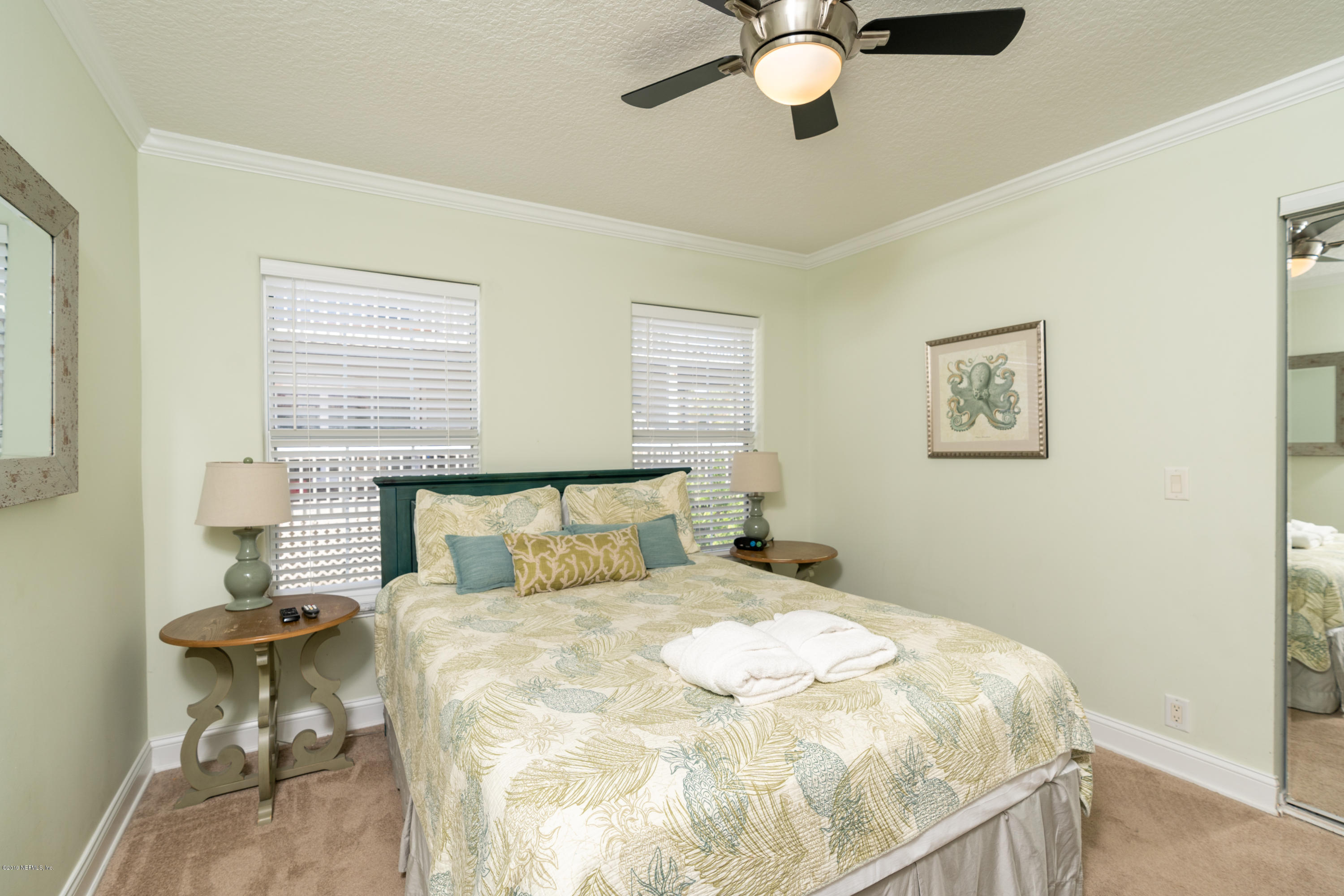 4 3rd Street St. Augustine, FL 32080 - Photo 28 of 47 a bedroom with a bed and chair