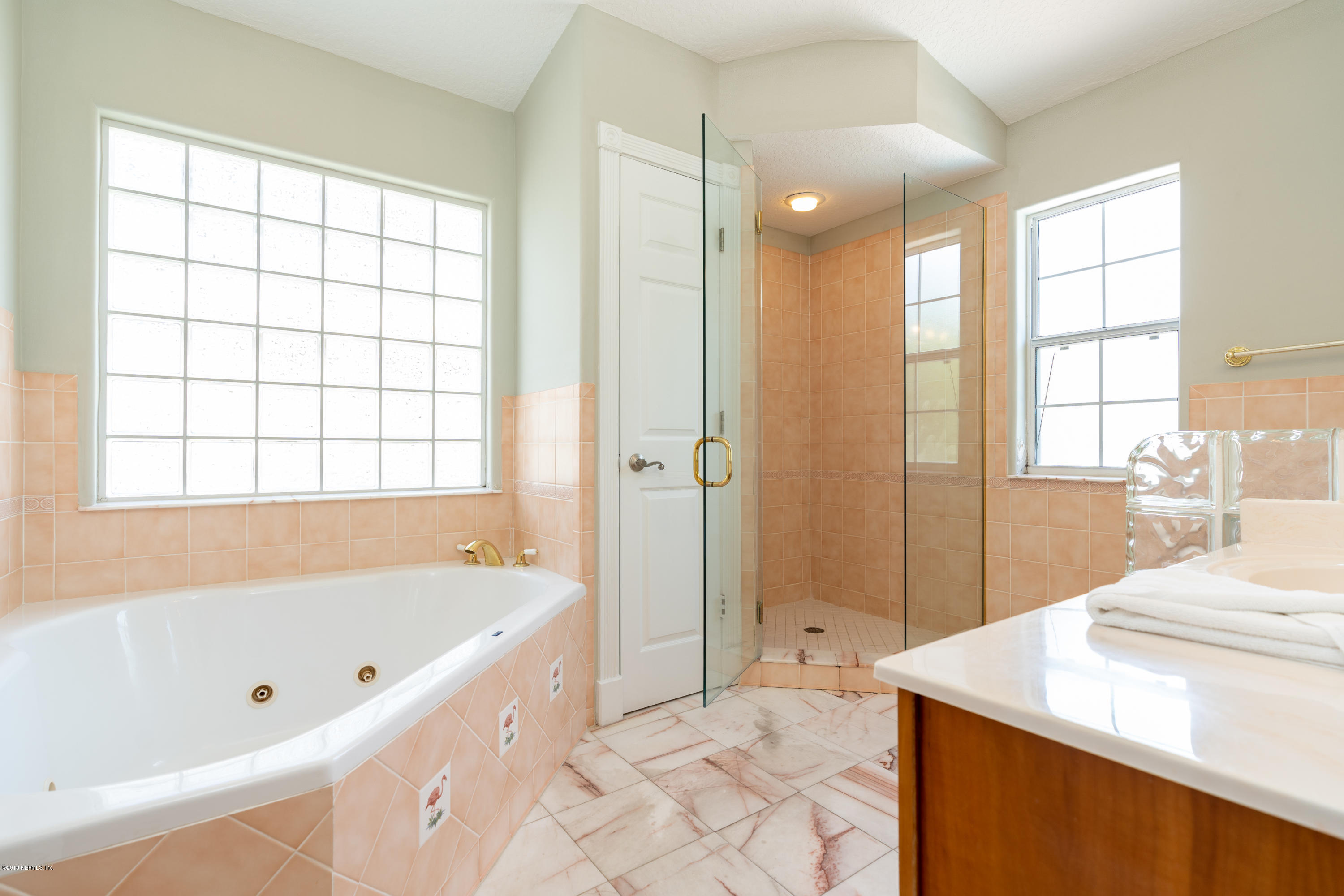 4 3rd Street St. Augustine, FL 32080 - Photo 31 of 47 a bathroom with a tub sink and mirror