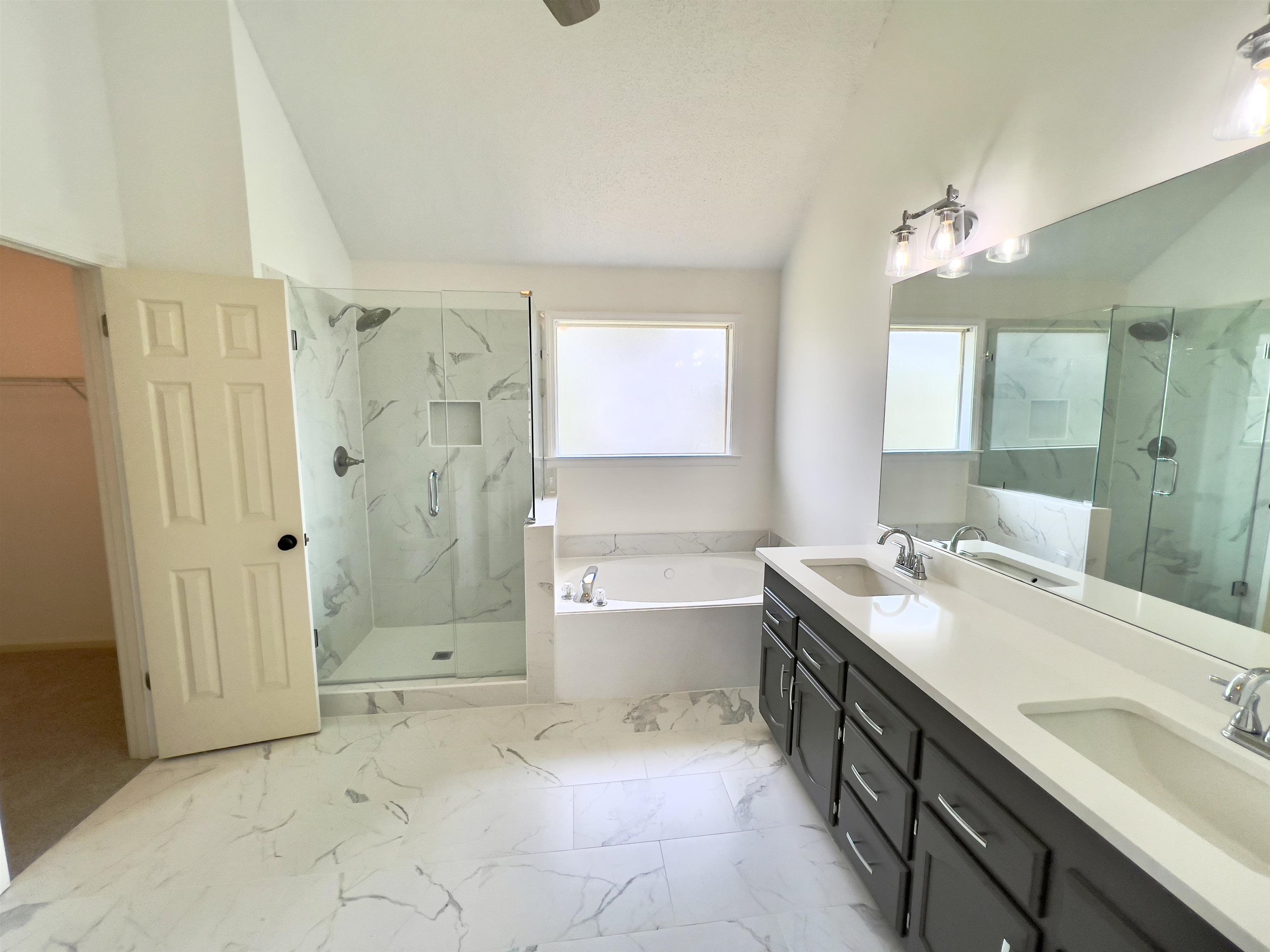 251 Cross Point Cove Collierville, TN 38017 - Photo 12 of 17 Bathroom featuring tile patterned floors, double sink vanity, and shower with separate bathtub