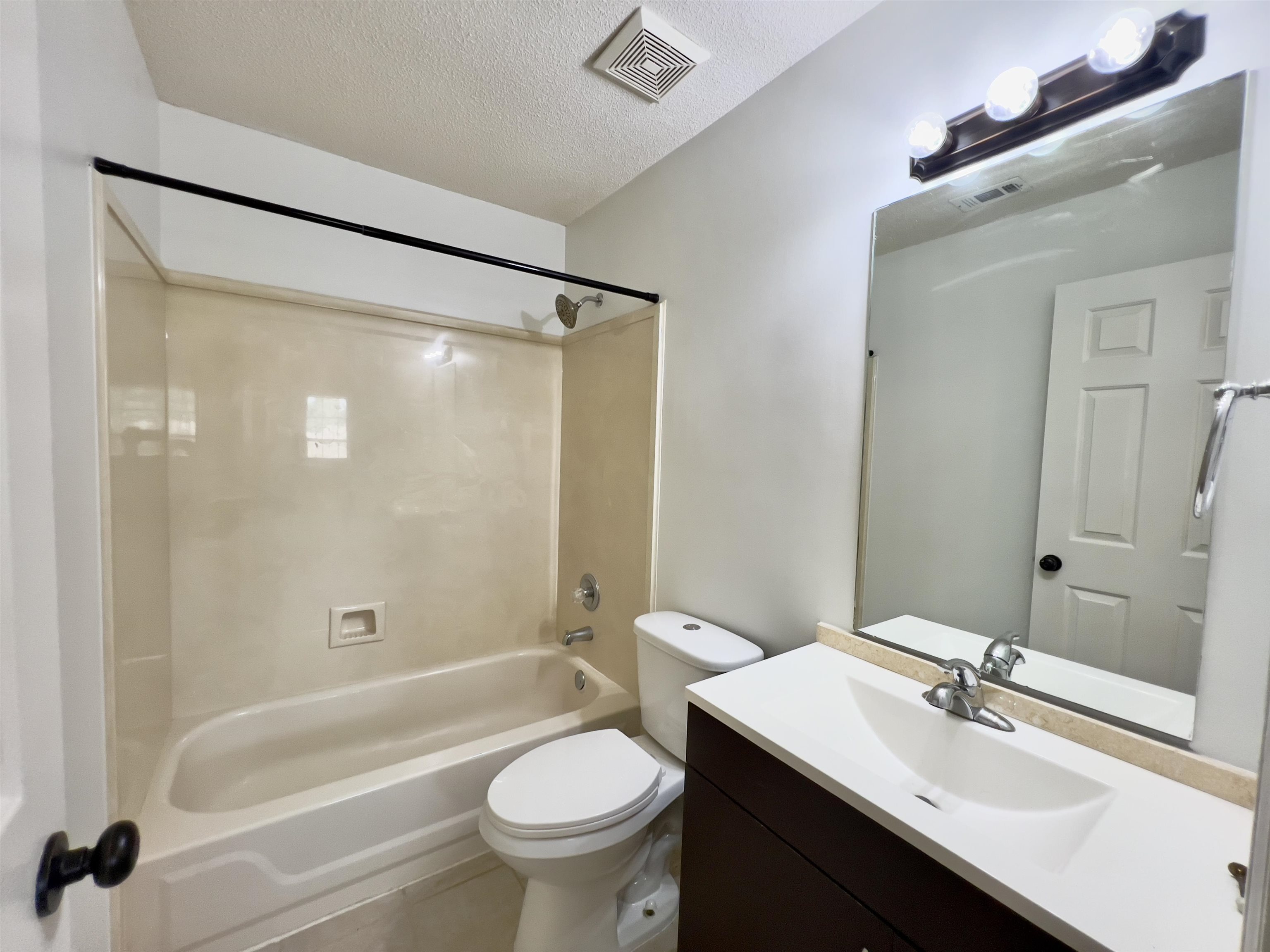 251 Cross Point Cove Collierville, TN 38017 - Photo 14 of 17 Full bathroom featuring toilet, vanity, tile patterned floors, shower combination, and a textured ceiling