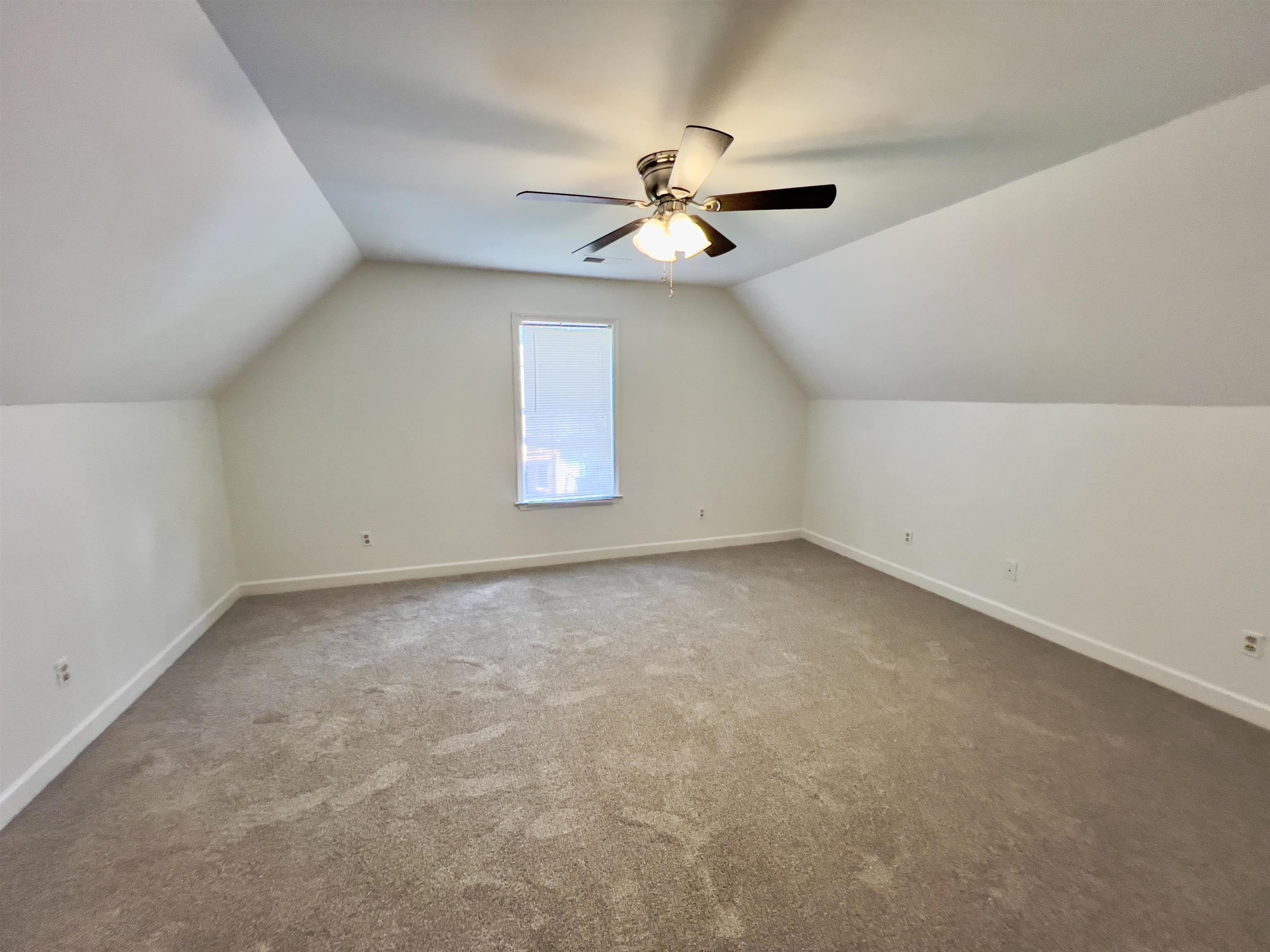 251 Cross Point Cove Collierville, TN 38017 - Photo 17 of 17 Bonus room with carpet floors, ceiling fan, and lofted ceiling