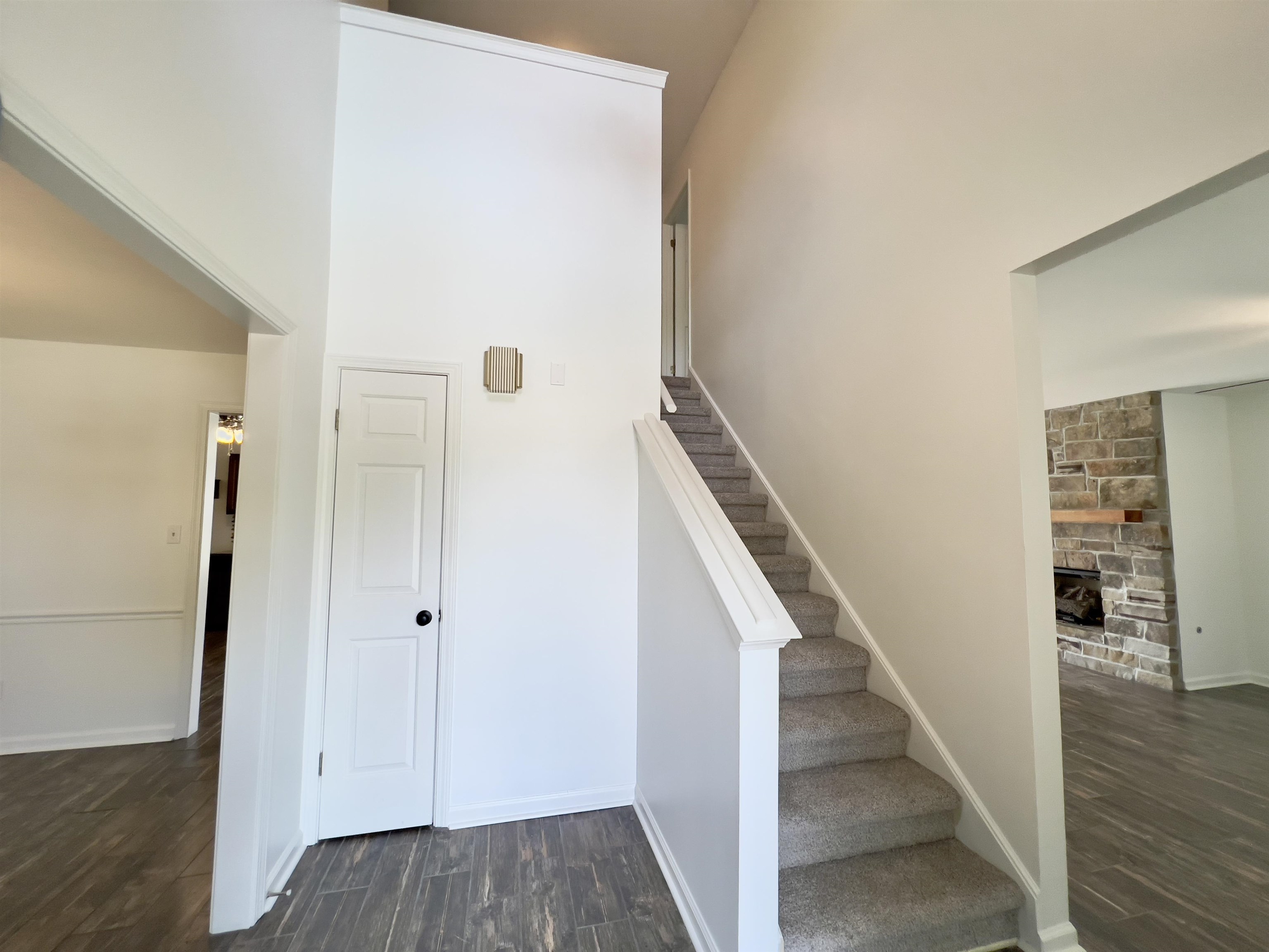 251 Cross Point Cove Collierville, TN 38017 - Photo 2 of 17 Stairs with a stone fireplace and wood-type flooring