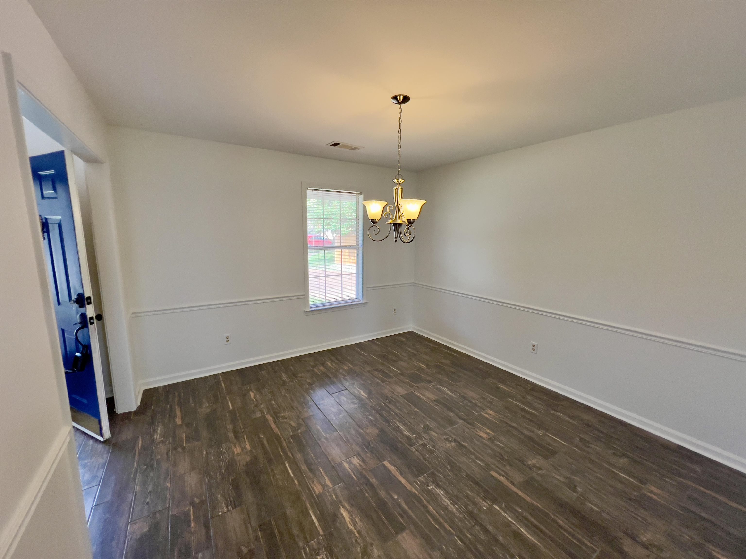 251 Cross Point Cove Collierville, TN 38017 - Photo 8 of 17 Unfurnished room with an inviting chandelier and dark hardwood / wood-style flooring