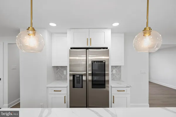 a view of a kitchen with a refrigerator and a window