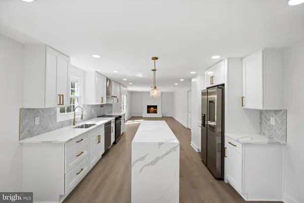 an empty room with wooden floor and window