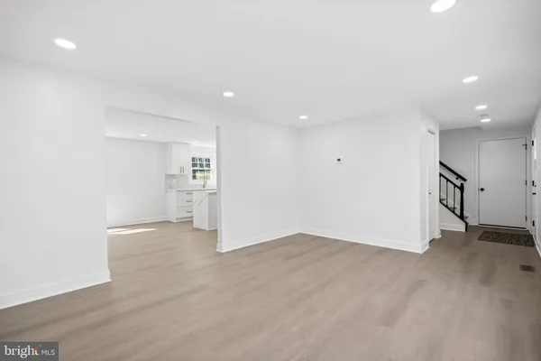 a kitchen with kitchen island granite countertop a sink cabinets and window