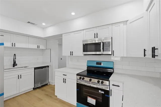 a kitchen with a stove and a microwave