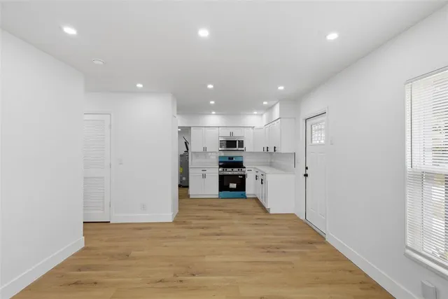 a view of a kitchen with a sink and a window