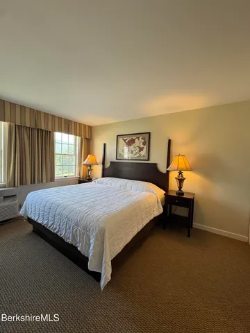 a kitchen with stainless steel appliances a dining table chairs and a refrigerator