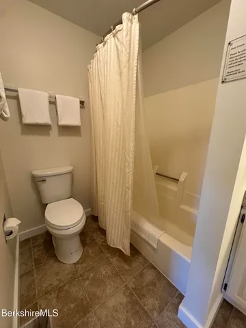 a en suite bathroom with a granite countertop sink and a mirror