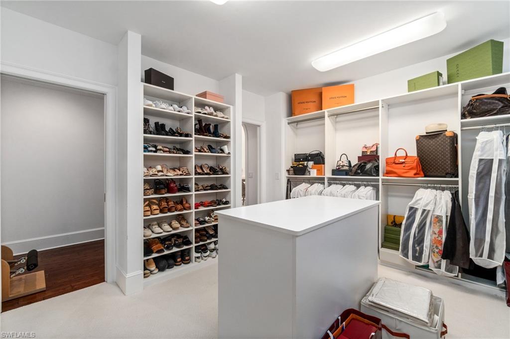 16755 Lucarno Way Naples, FL 34110 - Photo 15 of 50 a view of walk in closet with clothes and shoes