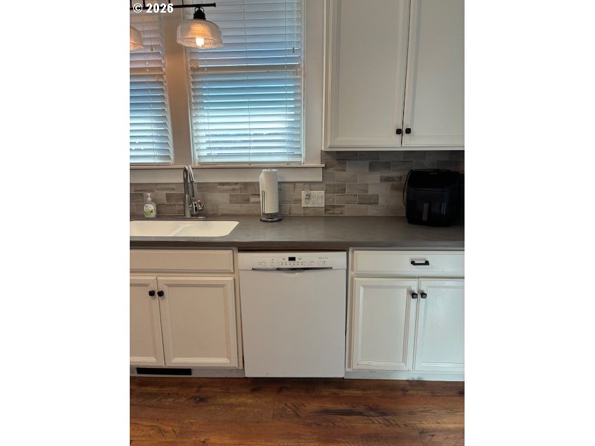 518 Northwest 4th Street Pendleton, OR 97801 - Photo 12 of 39 a kitchen with stainless steel appliances granite countertop a sink and a white cabinets