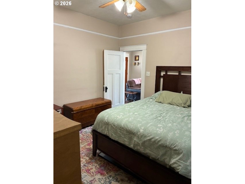 518 Northwest 4th Street Pendleton, OR 97801 - Photo 15 of 39 a bedroom with a bed and a chandelier