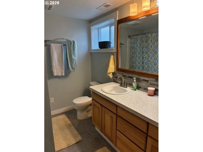 518 Northwest 4th Street Pendleton, OR 97801 - Photo 28 of 39 a bathroom with a granite countertop sink toilet and mirror