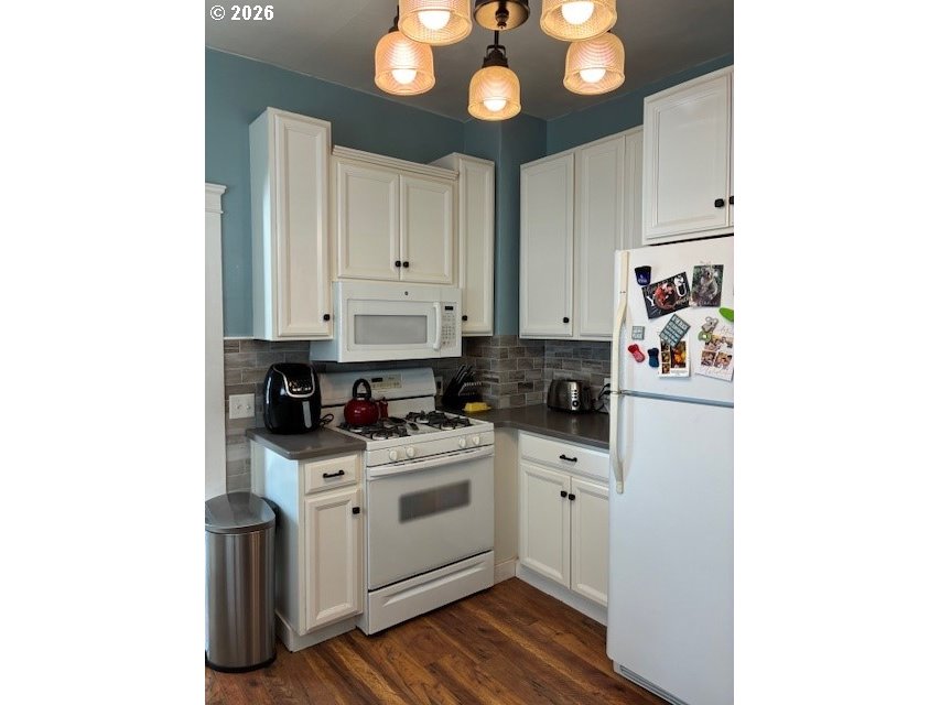 518 Northwest 4th Street Pendleton, OR 97801 - Photo 9 of 39 a kitchen with stainless steel appliances a stove a sink and cabinets