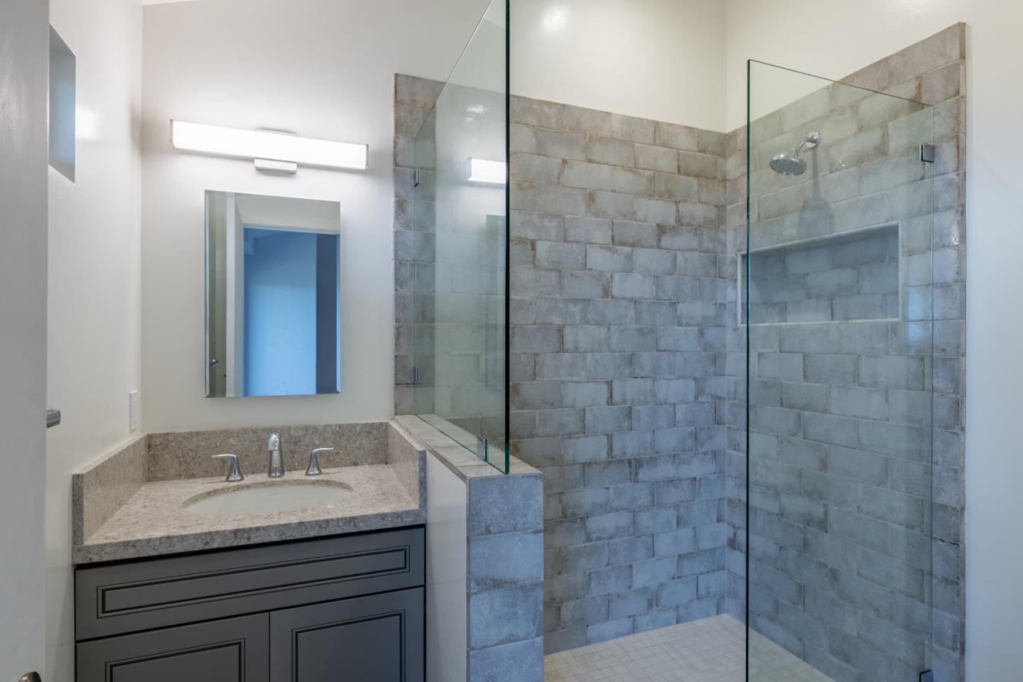 214 Crest Road Carmel, CA 93923 - Photo 23 of 29 a bathroom with a granite countertop sink a shower and a mirror