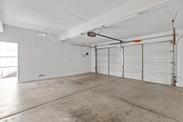 a open kitchen with cabinets and white stainless steel appliances