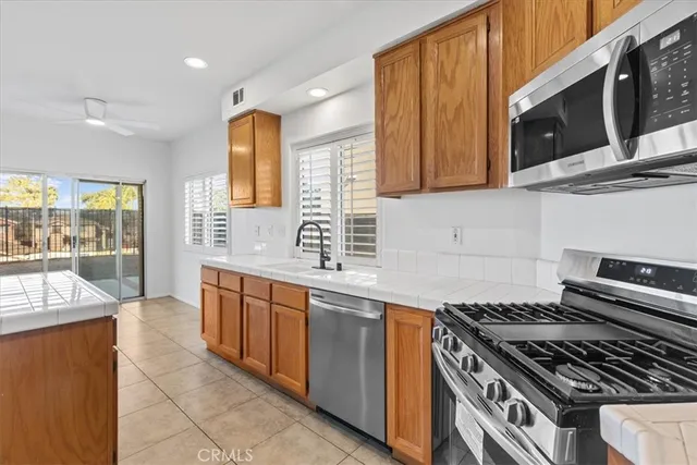 a view of kitchen with stainless steel appliances cabinets and wooden floor