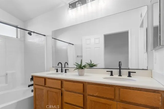 a bathroom with a granite countertop sink toilet and mirror
