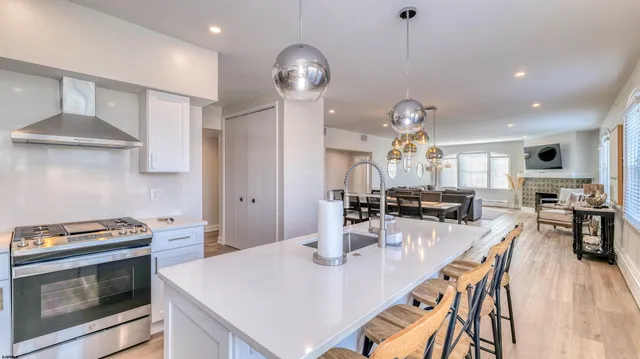 a kitchen with stainless steel appliances a dining table and chairs