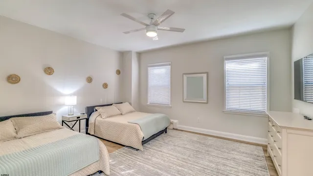 a bedroom with two beds and a window