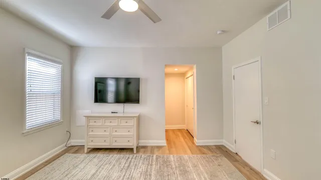 a view of a livingroom with furniture and a flat screen tv