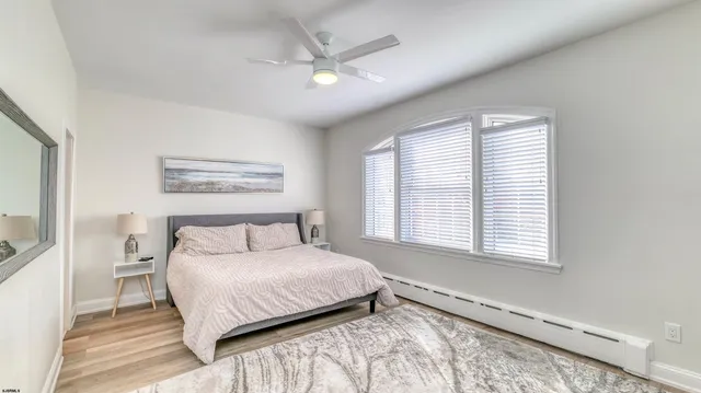 a bedroom with a large bed and a window