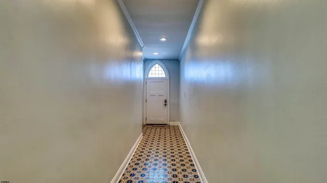 a view of hallway with wooden floor