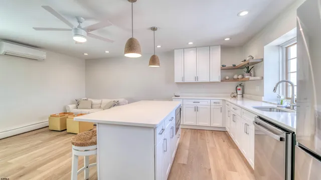 a kitchen with a sink a stove a refrigerator and cabinets