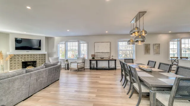 a living room with fireplace furniture and a flat screen tv