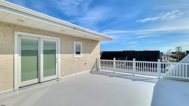 a view of balcony with floor to ceiling window