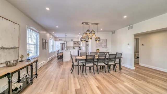 a view of a dining room with furniture and chandelier