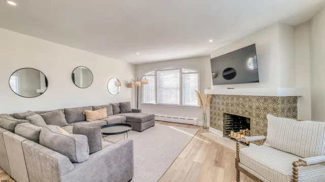 a living room with furniture and a fireplace