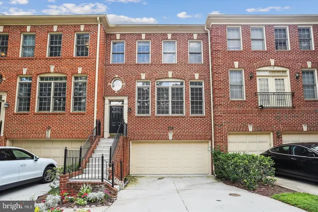 a front view of a building with a garden
