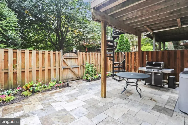 a view of a chairs and table in backyard