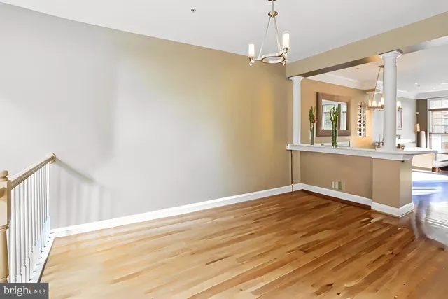 a view of a room with wooden floor and chandelier