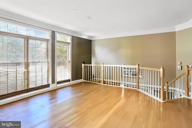 a view of a room with wooden floor and fence