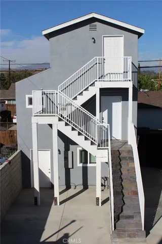 a view of a house with wooden deck
