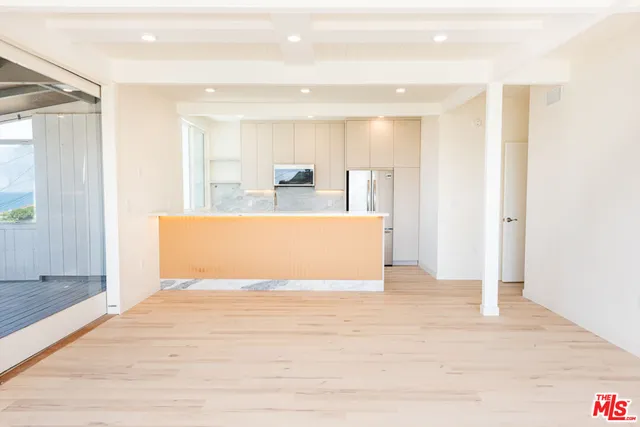 a view of kitchen with stainless steel appliances cabinets