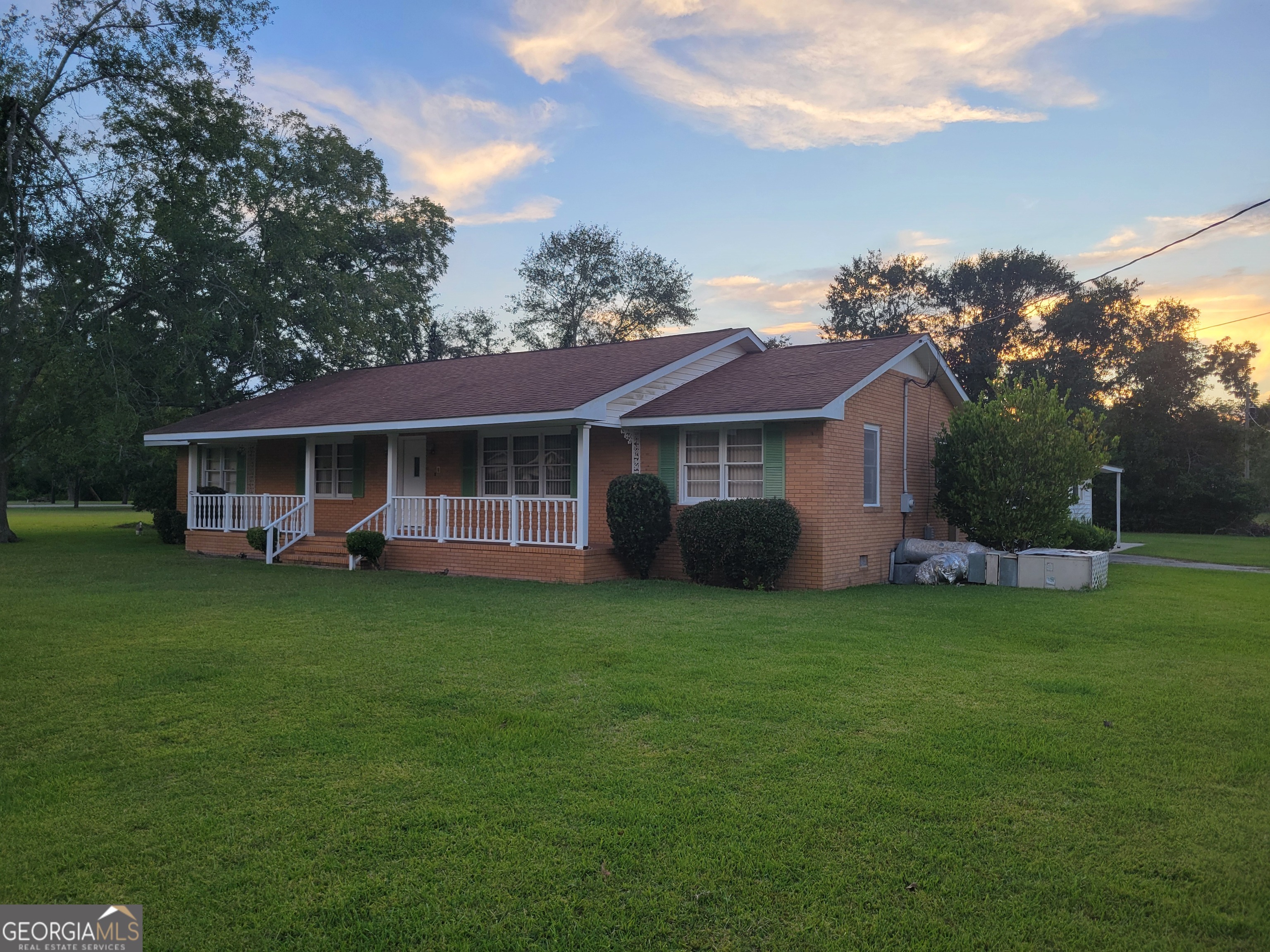 a front view of a house with a garden