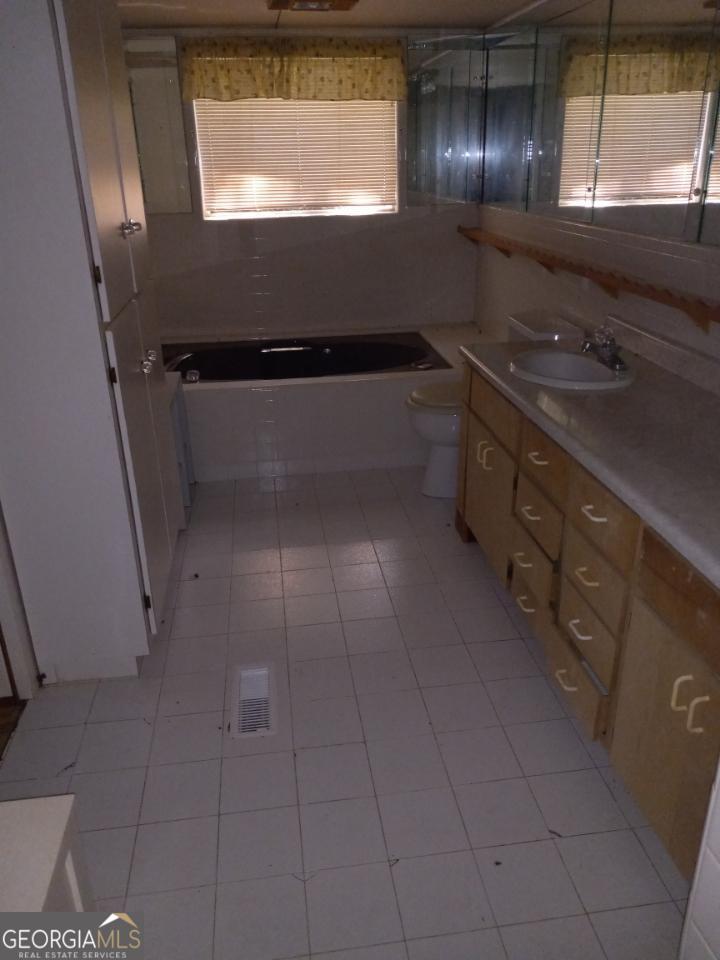 139 Moore Street Willacoochee, GA 31650 - Photo 14 of 33 a kitchen with a sink and cabinets