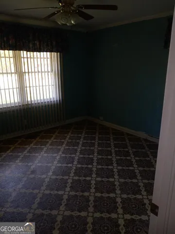 a kitchen with granite countertop a sink cabinets and wooden floor