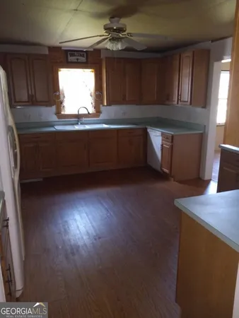 a kitchen with cabinets and white appliances