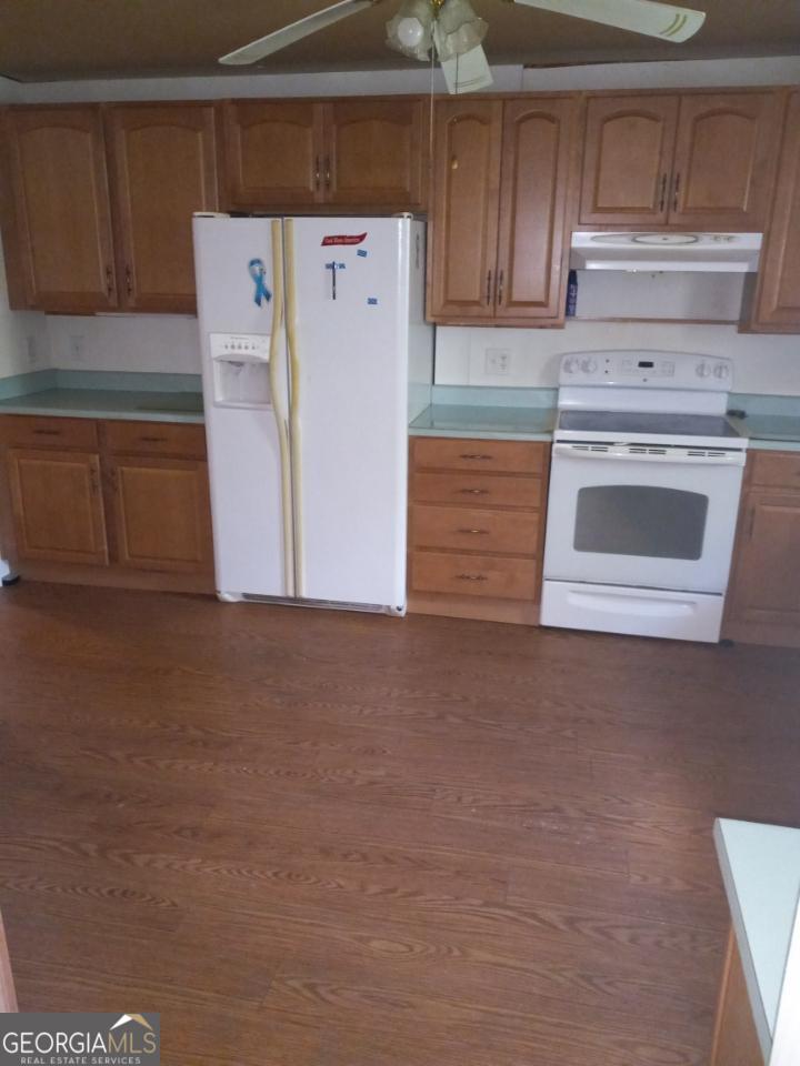 139 Moore Street Willacoochee, GA 31650 - Photo 18 of 33 a kitchen with cabinets and white appliances