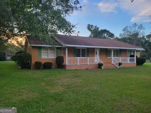 a front view of a house with a garden