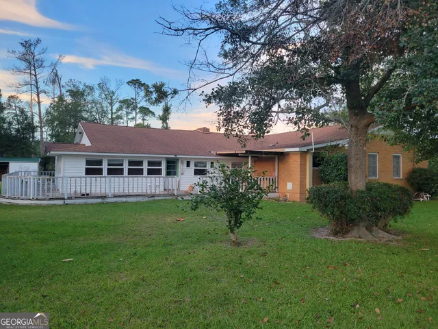 a front view of a house with a garden