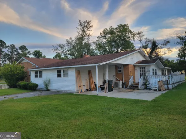 a front view of house with yard and outdoor seating